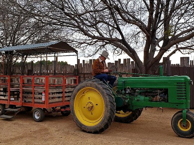 Giddy up, green machine! This tractor's hauling more than hay – it's carrying dreams of the Wild West.