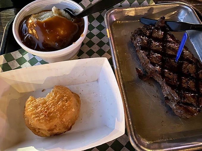 Meat lover's dream alert! This juicy strip steak, swimming in gravy, could make a vegetarian reconsider their life choices.