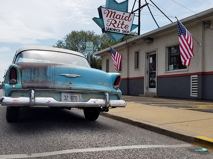 Classic cars and comfort food: a match made in nostalgic heaven. This scene is like a postcard from the past, with a side of fries.