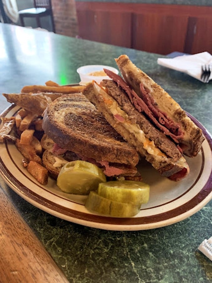 Behold, the Reuben in all its glory! Layers of corned beef, sauerkraut, and melted cheese nestled between grilled rye – it's a flavor verdict you can sink your teeth into.