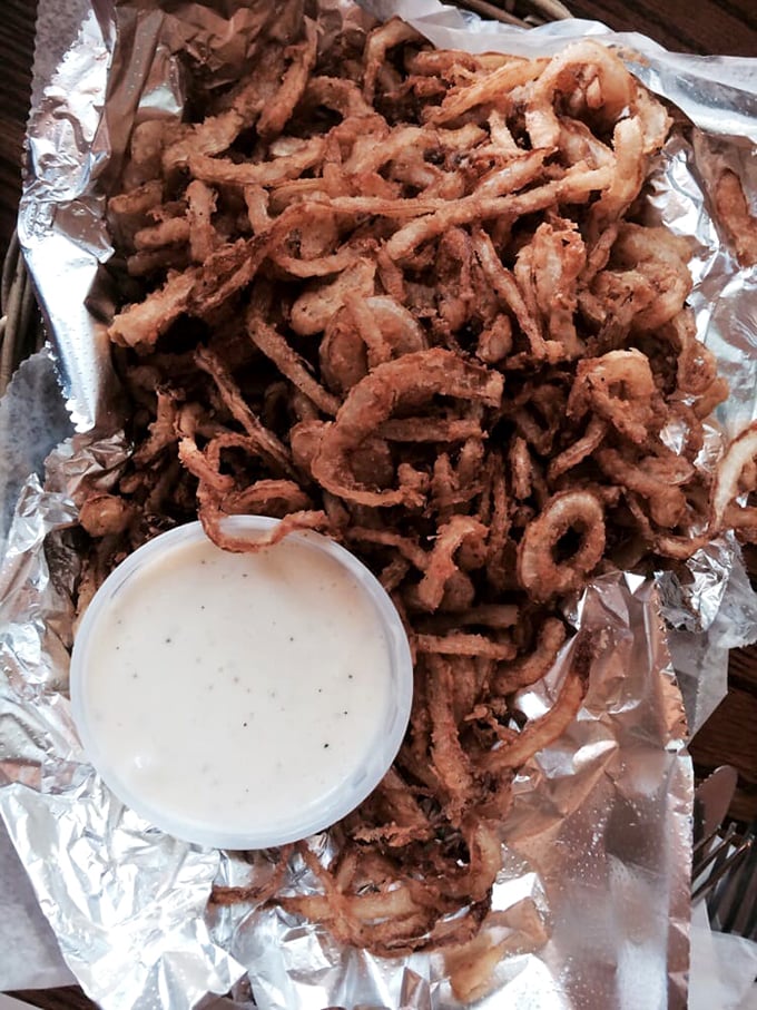 Onion rings: the unsung heroes of bar food. Crispy, savory, and piled high – they're like edible jewelry for your plate.