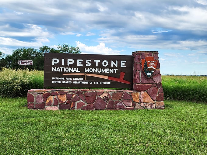 Welcome to Pipestone, where the rocks have more layers than a Minnesota winter wardrobe. This sign's just the appetizer for the feast of history ahead.