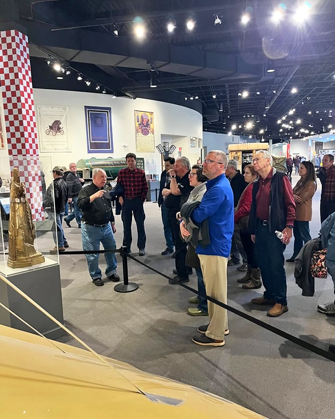 Look at these folks, drinking in automotive history like it's a fine wine. Can you spot the future classic car enthusiast?