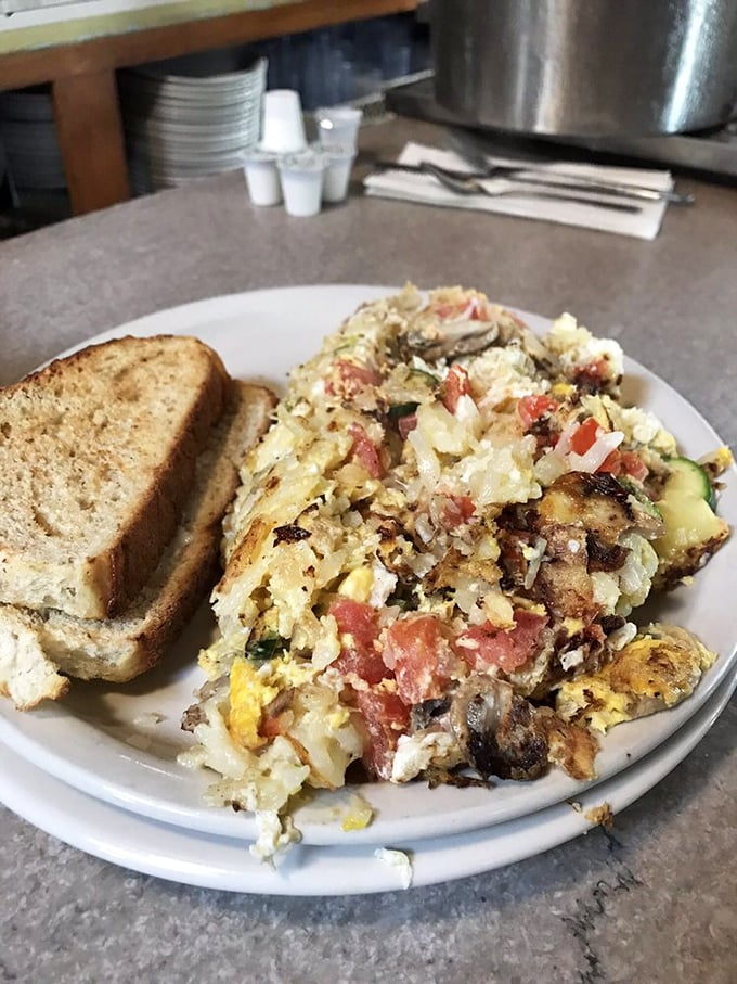 The infamous "Garbage Plate" in all its glory – a beautiful mess of eggs, veggies, and who-knows-what-else that's tastier than its name suggests.