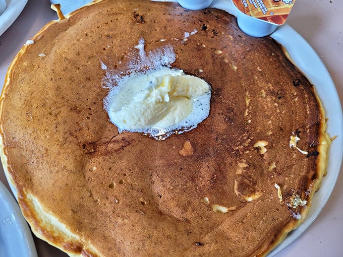 Holy flapjack, Batman! This pancake is so enormous, it might need its own zip code. Butter island in the center adds a touch of melty magic.