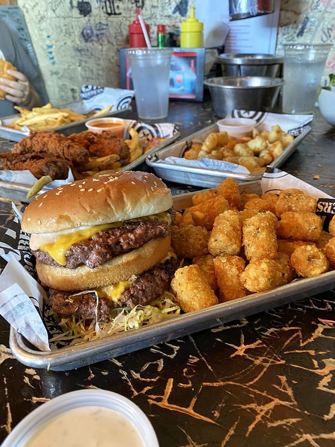 A trifecta of temptation! AJ Bombers' burger, tots, and cheese curds are the holy trinity of comfort food.