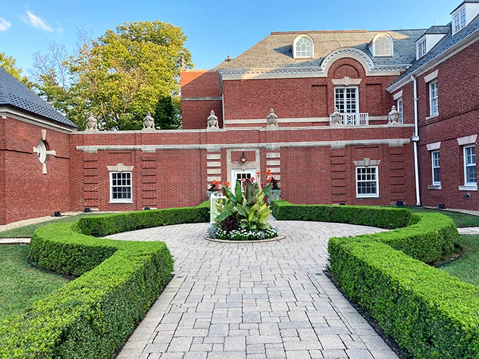 Brick beauty meets botanical bliss. This stately structure, adorned with urns and greenery, whispers tales of elegant garden parties past. Photo credit: Mike Shen