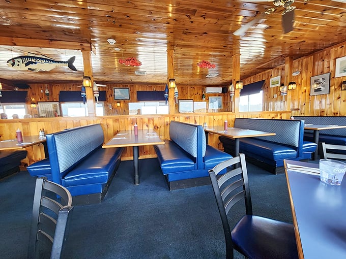 Knotty pine walls and navy blue booths create the perfect maritime mood, while whimsical fish sculptures keep watch from above. Photo credit: Rafal G.