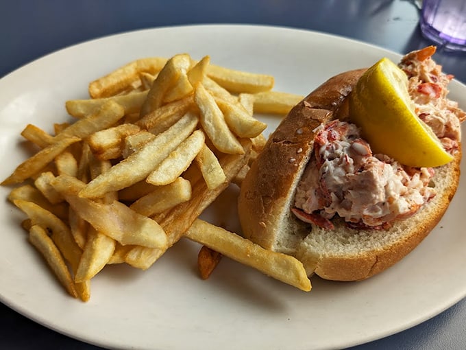 A proper Maine lobster roll, generously stuffed and served with golden fries - summer on a plate. Photo credit: David Carr