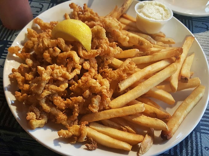 These golden-fried clams are what seafood dreams are made of - crispy, tender, and begging for a squeeze of lemon. Photo credit: Lola Consuela