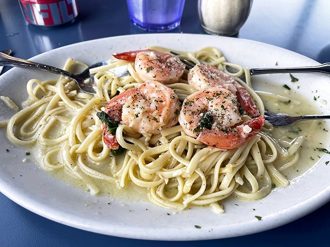 Plump shrimp nestled in a tangle of perfectly cooked linguine - Italian meets New England in delicious harmony. Photo credit: Chidi Amasiani