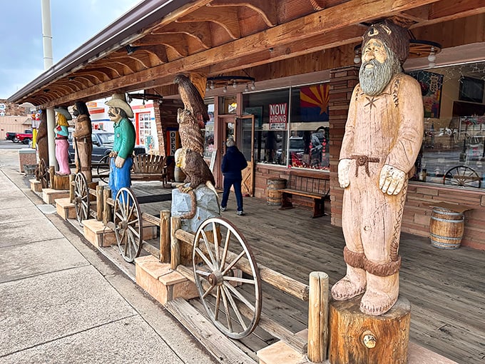 Howdy, partner! These wooden cowboys are standing guard, probably reminiscing about the good ol' days of $0.25 gas.