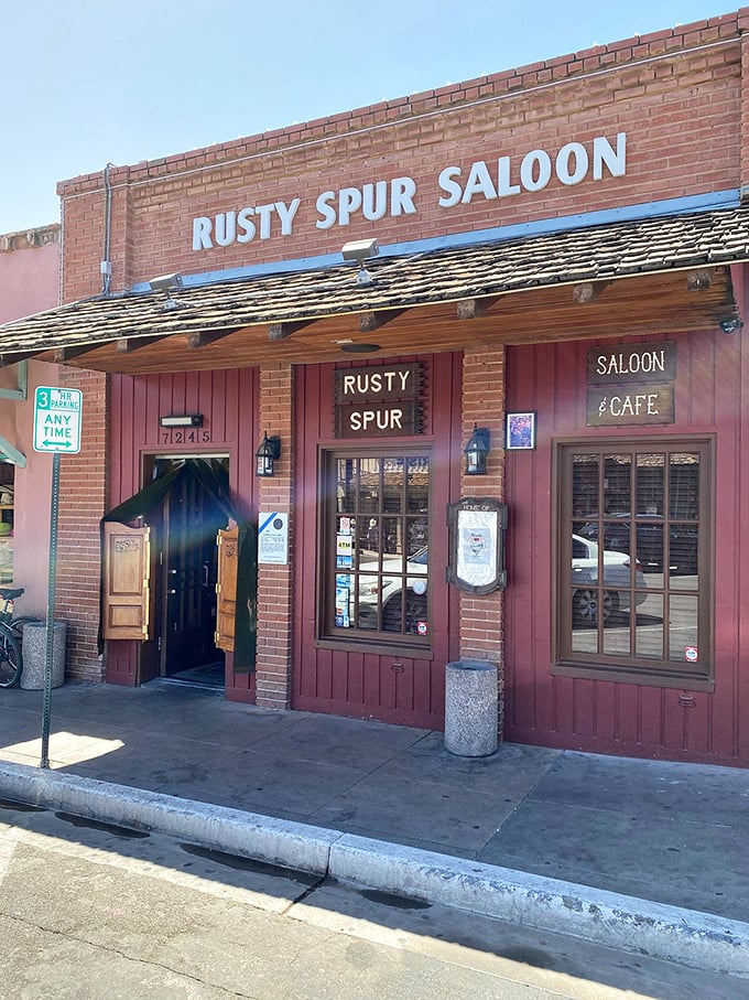 Swinging doors and neon signs—a time machine disguised as a saloon entrance. John Wayne would feel right at home sidling up to these weathered planks.