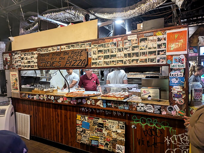 The wizards behind the pizza curtain! These culinary maestros are orchestrating a symphony of flavors right before your eyes.