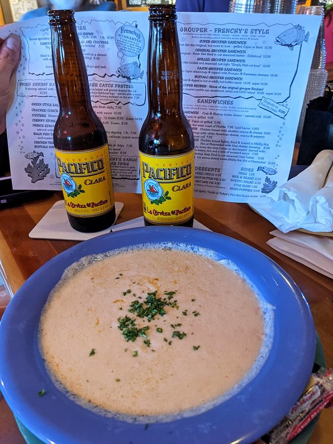 Double trouble, seafood style! Two bowls of Frenchy's famous soup, flanked by cold brews. It's like a beach party for your taste buds!