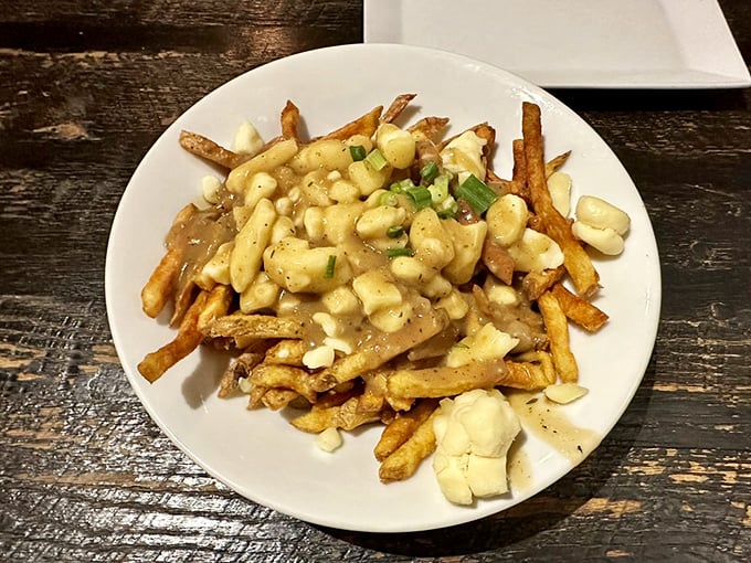 Behold, the poutine that launched a thousand food comas! This mountain of crispy fries, gravy, and cheese curds is like a warm hug for your taste buds.