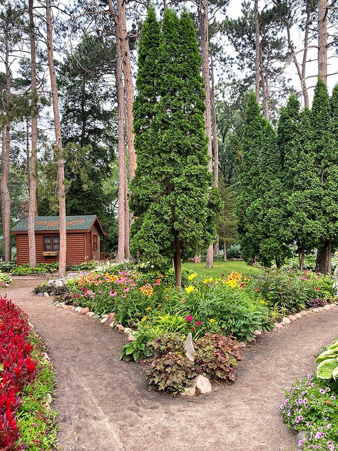 Little cabin in the flowers! Is this where the garden gnomes vacation? A whimsical hideaway amidst the blooms.