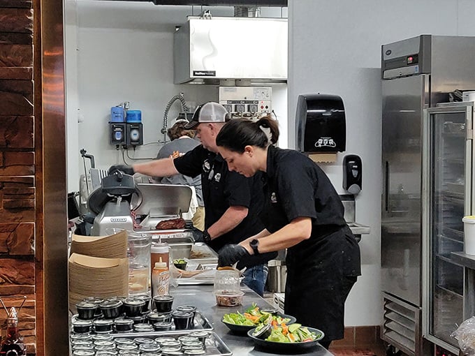 Behind the scenes of deliciousness! The hardworking staff, crafting BBQ magic that'll make you want to hug the chef.