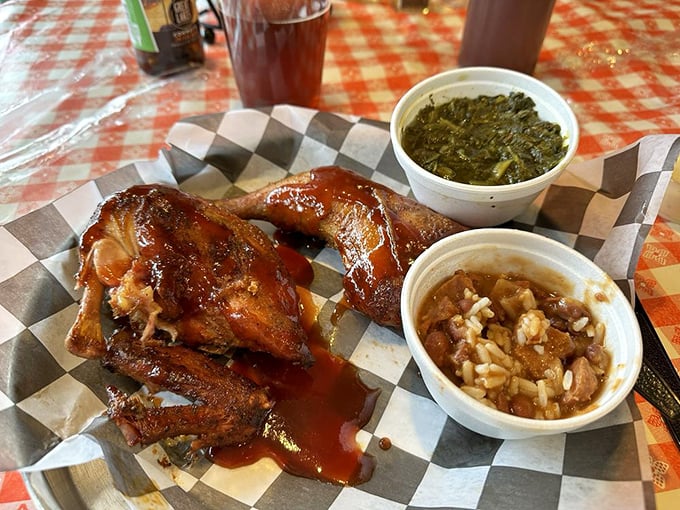 Behold, the BBQ chicken in all its glazed glory! Nestled alongside collard greens and baked beans, it's a Southern-inspired symphony on a plate.