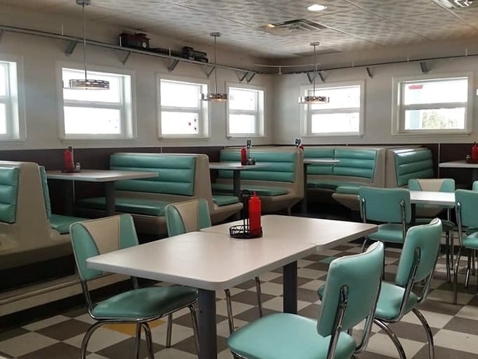 Dining area straight out of a retro dream. These booths have probably heard more stories than a barber's chair.