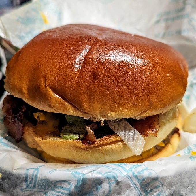 Bacon Cheeseburger: The holy trinity of comfort food. This burger is stacked higher than your vinyl collection from the '70s.