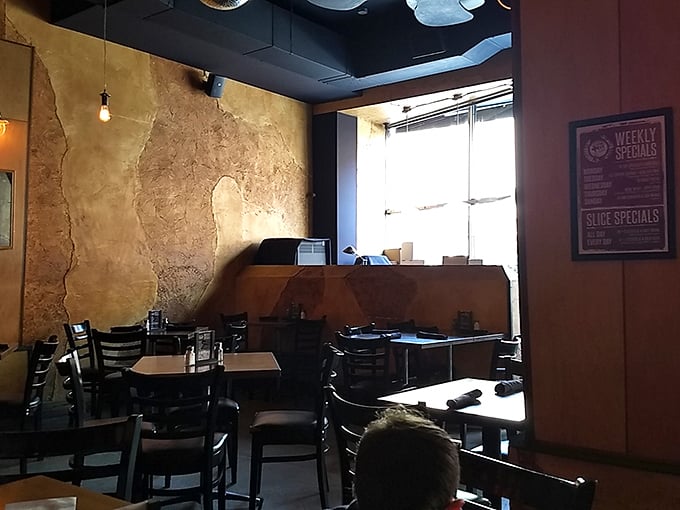 Rustic charm meets modern cool. This dining area is where pizza dreams and friendly chatter harmoniously collide.