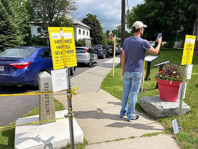 Look ma, I'm in two places at once! Visitors play hopscotch with an international border, proving diplomacy can be fun.