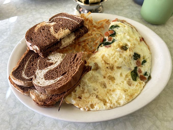 Egg-cellent choice! This omelet is so fluffy, it might float away if it weren't anchored down by melty cheese and crispy toast.