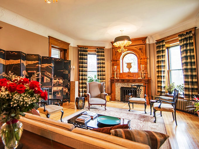 Downton Abbey, Wisconsin-style! This formal parlor screams elegance with its ornate fireplace and plush seating – perfect for plotting your next move.