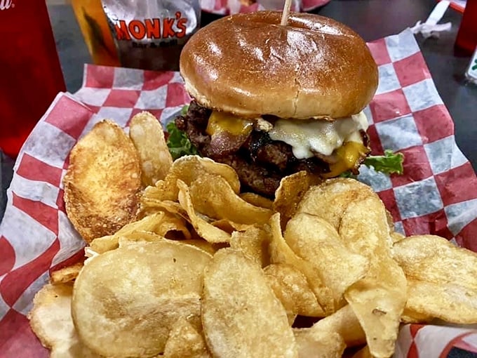 Holy cow! This burger is so tall, it needs its own area code. Packed with flavor and topped with crispy chips, it's a towering testament to indulgence.