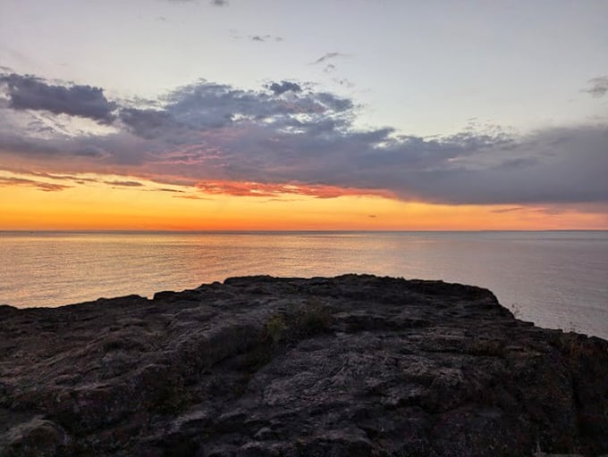 Sunset over Lake Superior: where the sky puts on a light show that would make Broadway jealous. No tickets required!