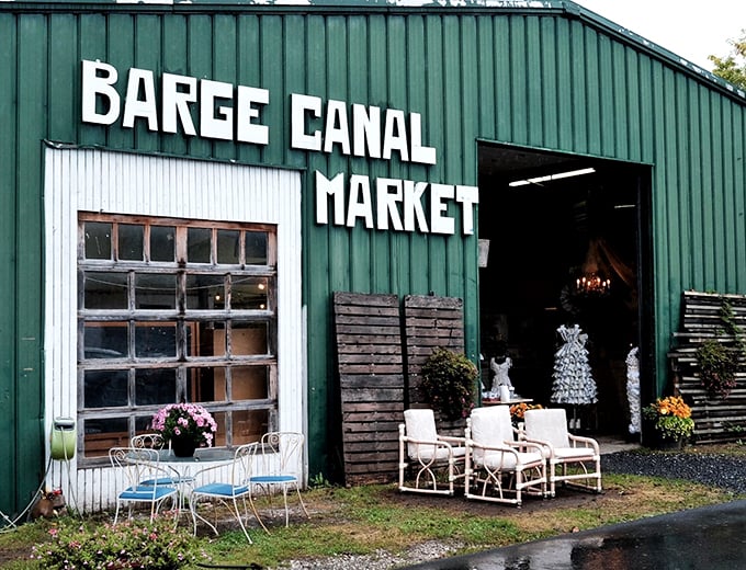 Green giant or antique warehouse? Barge Canal Market stands tall, promising treasures as vibrant as its exterior!