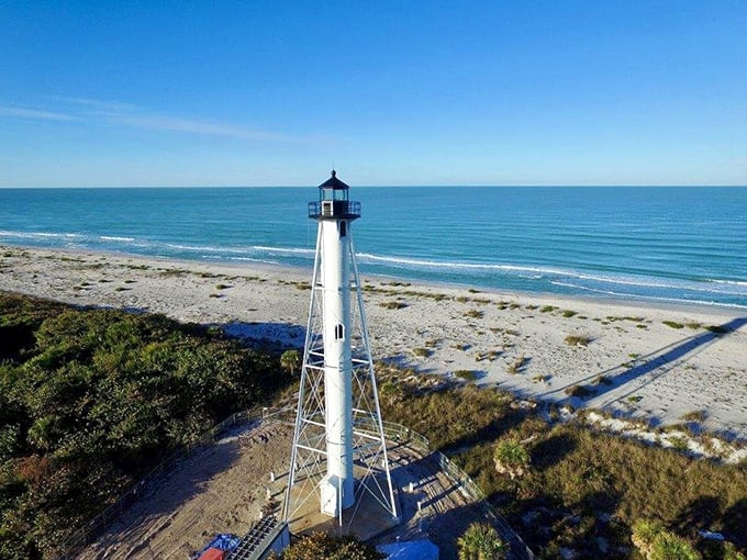 Beach, please! This bird's-eye view of the lighthouse and shoreline is giving serious vacation vibes.