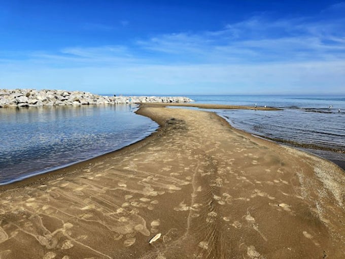 Nature's infinity pool: Where the sand meets the sky, creating a horizon that stretches further than your vacation days.