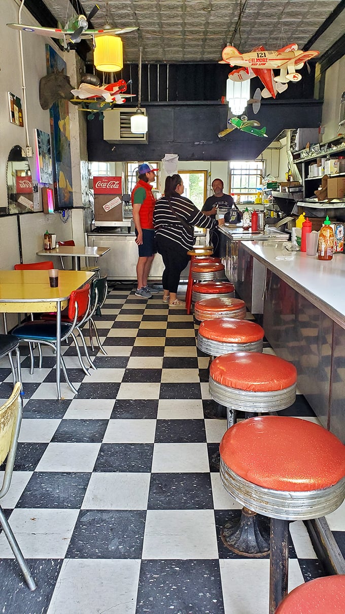 Step into a time machine disguised as a diner! The Wienery's interior is a delightful mishmash of retro chic and quirky charm, complete with model airplanes soaring overhead.