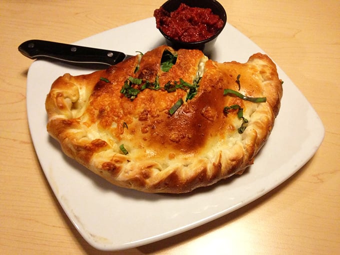 Behold, the calzone in all its glory! It's like a pizza decided to become a supermodel and hit the gym.