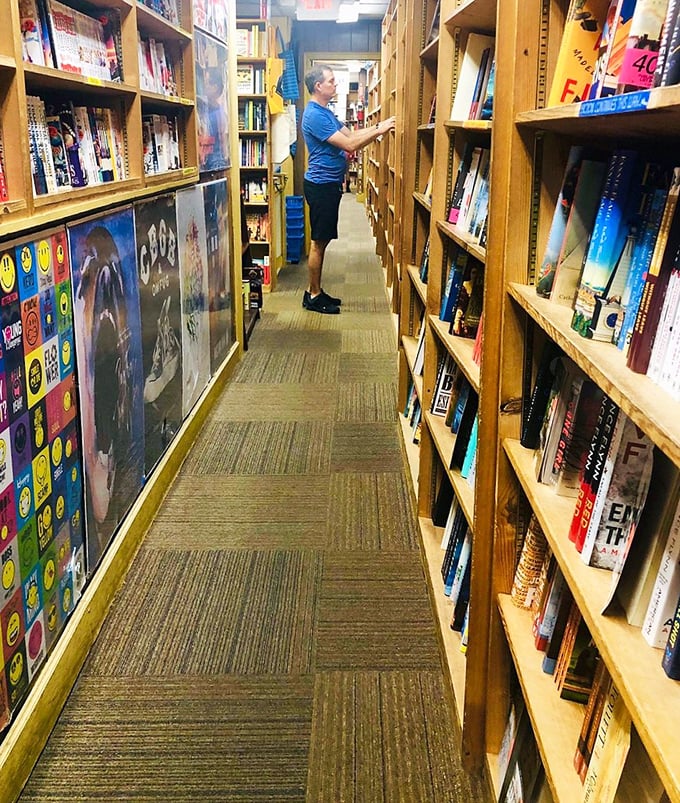 Lost in the stacks! This book hunter's determined pose is all too familiar to those who've embarked on literary treasure hunts.