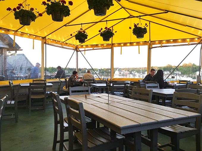 Under the cheerful yellow awning, every table feels like the best seat in the house. It's dinner and a show, starring the harbor.