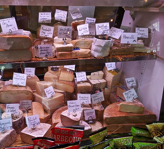 Cheese, glorious cheese! This display case is like a museum of dairy delights, each wedge a masterpiece waiting to be savored.