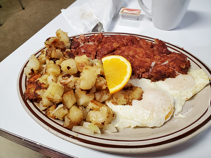 The breakfast trifecta: crispy hash browns, perfectly fried eggs, and... is that corned beef hash? Pinch me, I must be dreaming!