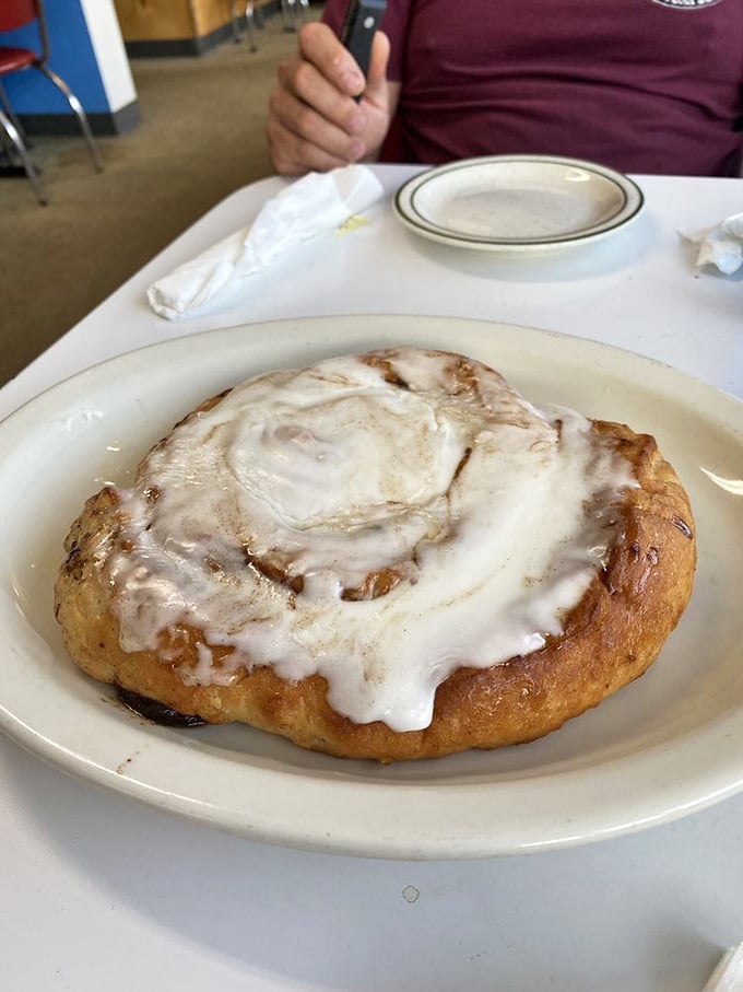 Behold, the eighth wonder of the breakfast world! This cinnamon roll is so big, it needs its own zip code. Fork and knife required!