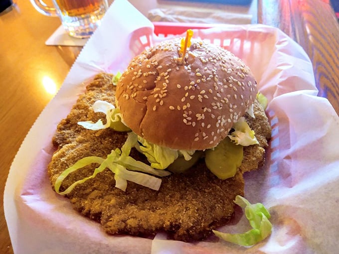 Ladies and gentlemen, I present to you the star of the show: a tenderloin sandwich so massive, it's practically a frisbee with a bun!