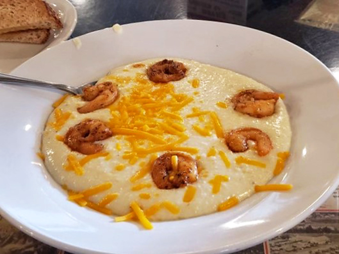 Cheesy does it! These shrimp and grits are living their best life, swimming in a sea of melted goodness. It's comfort food nirvana.