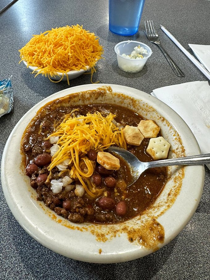 Chili perfection, Cincinnati-style! This hearty bowl, crowned with a mountain of cheese, is like a warm hug for your stomach.