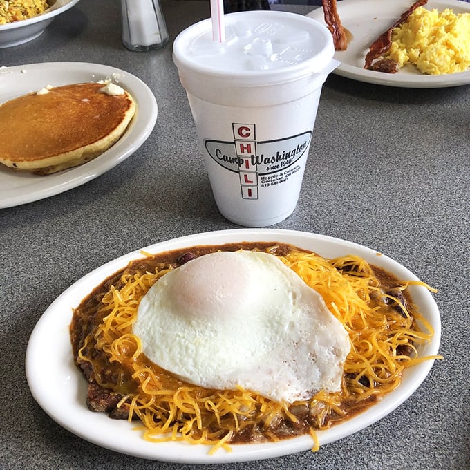 Breakfast of champions! Chili, goetta, and a sunny-side-up egg join forces to create the ultimate morning power trio.