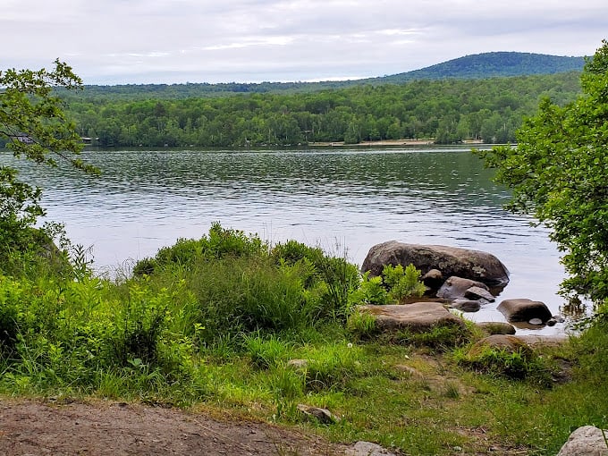 Groton's liquid gem: Where tranquility meets adventure. This pristine lake invites you to dive into serenity or paddle your worries away.