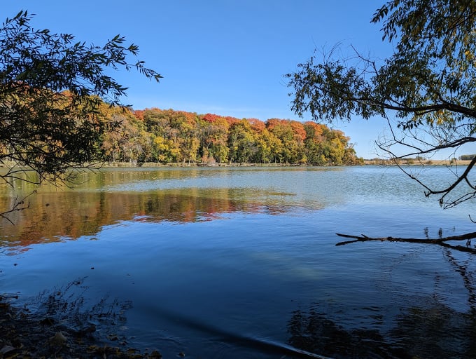 Fall foliage frames a serene lake view. It's like Mother Nature's own masterpiece, no museum admission required. Photo credit: Mike Lieb