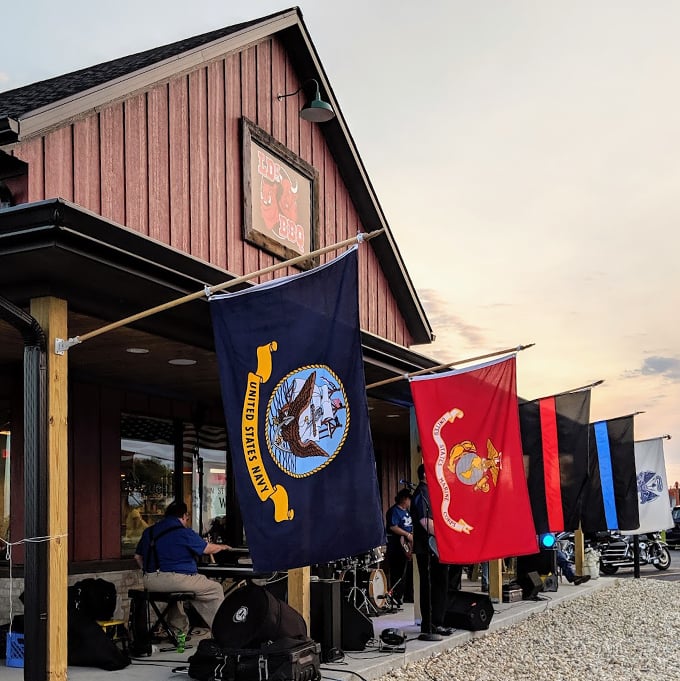 Military flags flying high, BBQ smoking low and slow. It's patriotism you can taste – God bless America, and pass the ribs! Photo credit: Wendy Solum