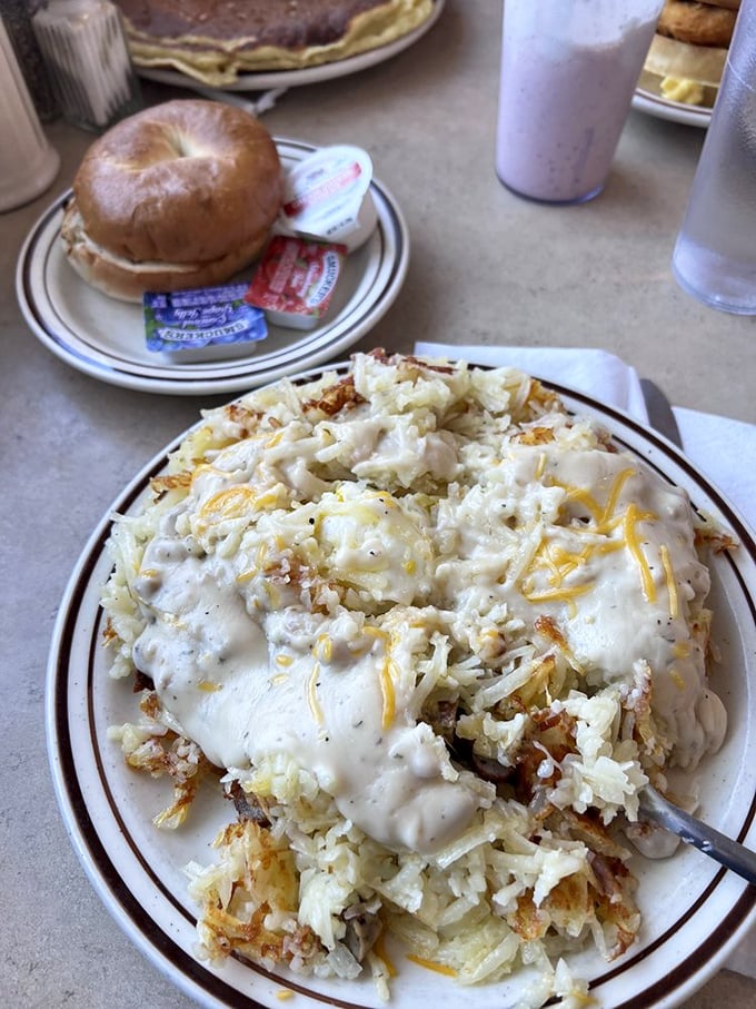 Holy hash browns, Batman! This cheesy, gooey mountain of potato perfection looks like it could fuel an entire Packers offensive line. Fork not included – you might need a shovel.