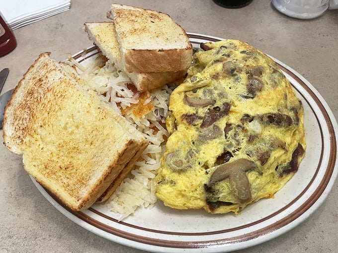 This isn't just an omelet; it's an egg-shaped treasure chest filled with cheesy, meaty goodness. It's so packed, it makes clown cars look spacious!